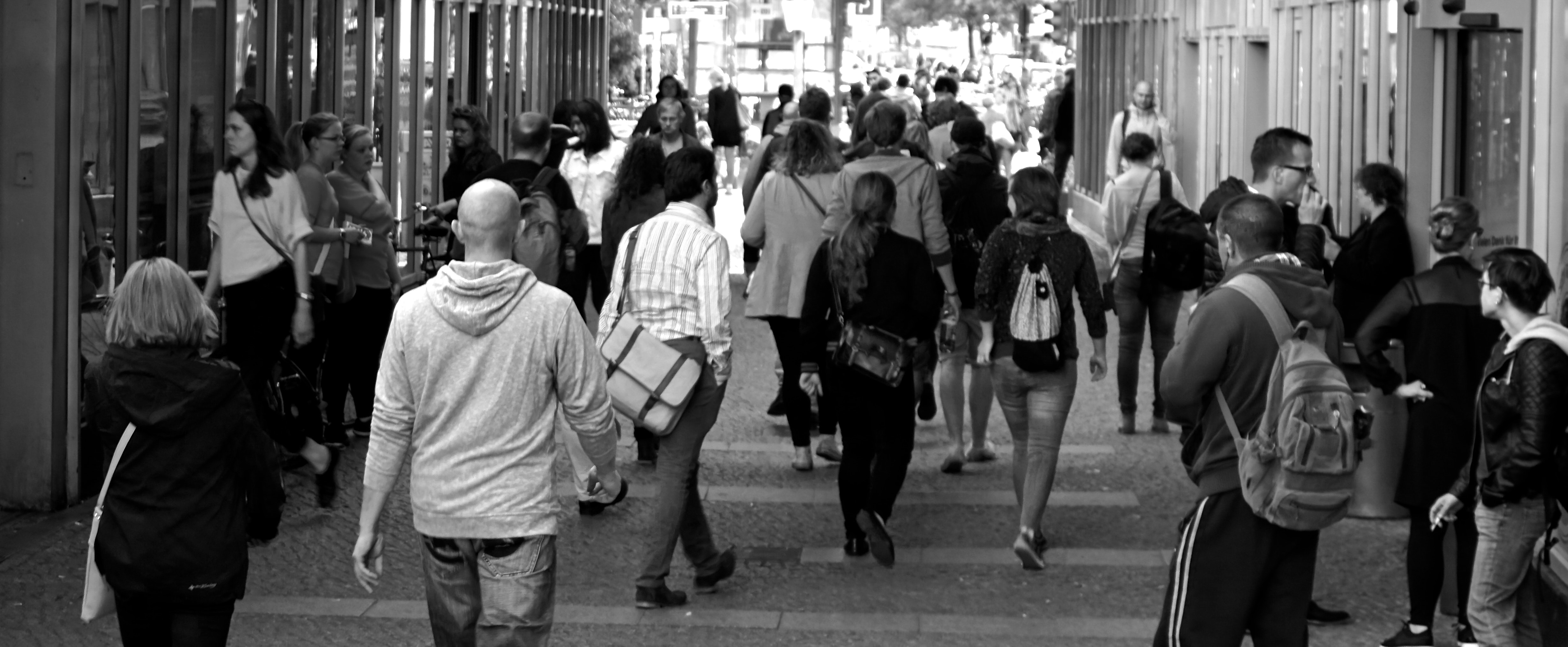 Image of people walking around in black and white