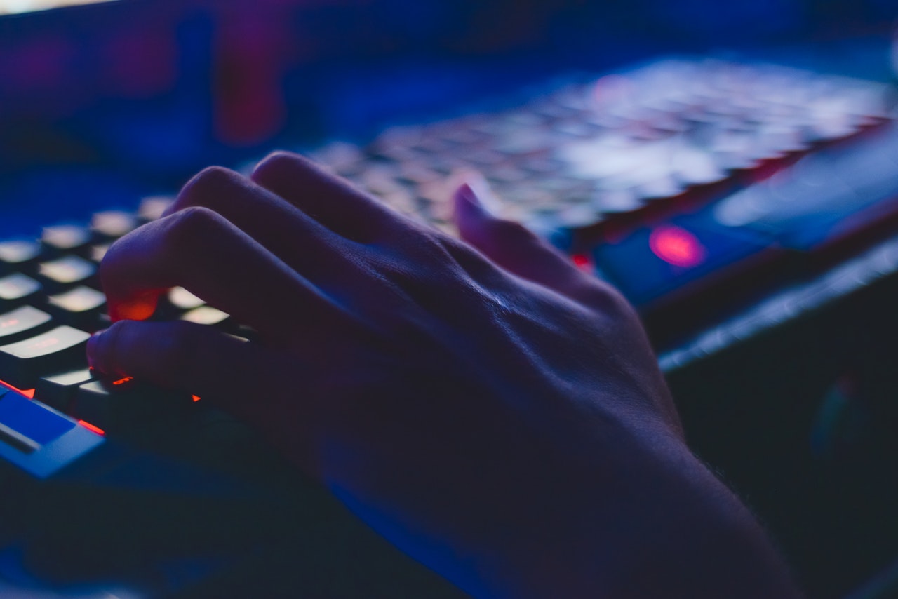 Dark image of keyboard and hand typing